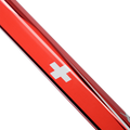 Close-up of a red metal object with a white cross emblem on a white background